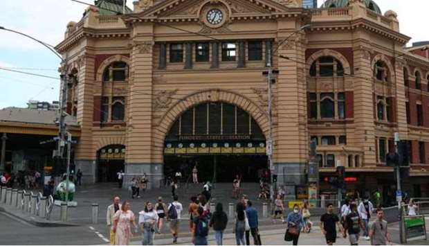 People enter and exit Flinders Street Station after a quarantine hotel worker tested positive for the coronavirus disease (Covid-19) and new public health measures were announced in Melbourne, Australia. 
