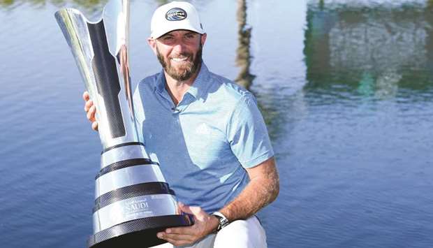 Dustin Johnson with the winners trophy after the final round of the Saudi International yesterday.