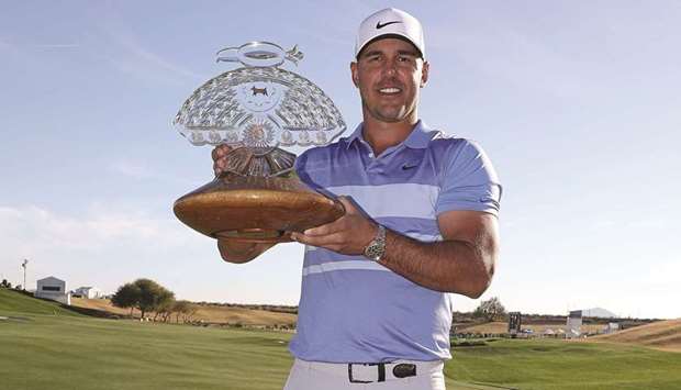 Brooks Koepka of the United States poses with the trophy after winning the Waste Management Phoenix Open at TPC Scottsdale in Scottsdale, Arizona. (Getty Images/AFP)
