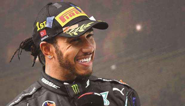 In this file photo taken on November 15, 2020, Mercedesu2019 British driver Lewis Hamilton gives an interview after winning the Turkish Formula One Grand Prix at the Intercity Istanbul Park circuit in Istanbul. (AFP)