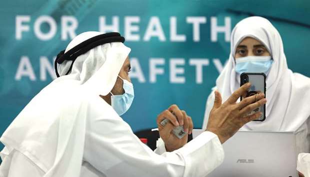 A man registered for receiving a dose of vaccine against the coronavirus at a vaccination centre at the Dubai International Financial Center in Dubai on February 3. While Dubaiu2019s Purchasing Managersu2019 Index fell to 50.6 in January from 51 last month, driven by a decrease in output and new orders, the gauge still remained above the 50 mark that separates growth from contraction.