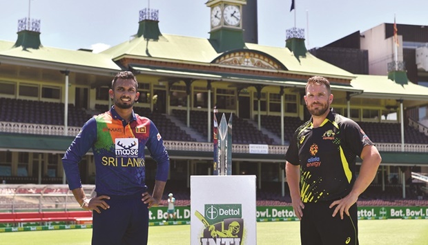 Australian captain Aaron Finch (right) with his Sri Lankan counterpart Dasun Shanaka pose with the 2022 Dettol T20 International Series trophy at the Sydney Cricket Ground yesterday. (AFP)