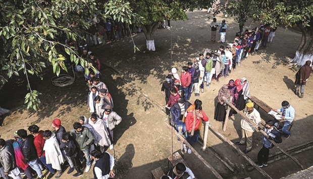 Voters queue up to cast their ballot at a polling station in Meerut during the first phase of Uttar Pradesh state assembly elections yesterday.
