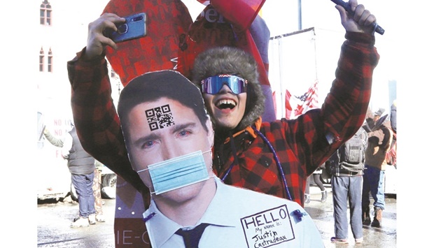This picture taken on Saturday shows a protester with a cutout image of Prime Minister Trudeau during a protest in Ottawa against coronavirus disease (Covid-19) vaccine mandates.
