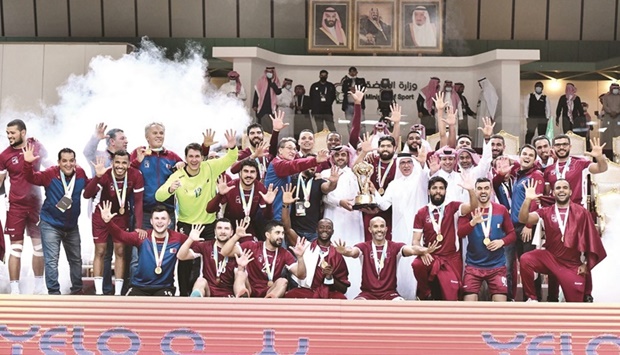 Qatar players and officials celebrate with the trophy after winning the fifth consecutive Asian Handball Championship title in Dammam on Monday.
