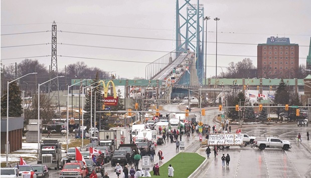 Anti-vaccine mandate protesters block the roadway at the Ambassador Bridge border crossing, in Windsor, Ontario yesterday. The protesters who are in support of the Truckers Freedom Convoy in Ottawa have blocked traffic in the Canada bound lanes from the bridge since February 7. About 23mn worth of goods cross the Windsor-Detroit border each day at the Ambassador Bridge making it North Americau2019s busiest international border crossing.