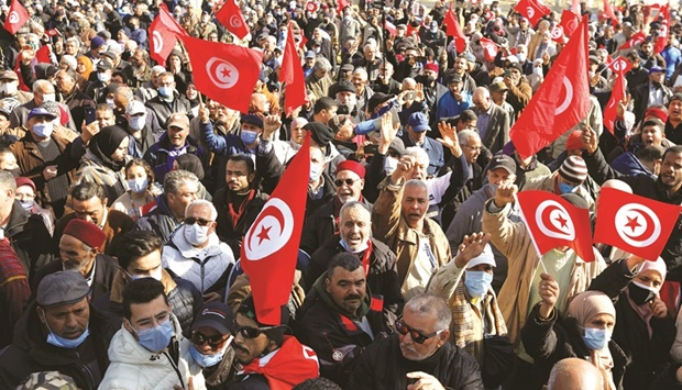 Demonstrators take part in a protest against Tunisian President Kais Saiedu2019s seizure of governing powers, in Tunis yesterday.