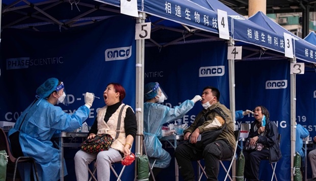 People are tested at a temporary testing site for Covid-19 in Hong Kong on February 12, as authorities scrambled to ramp up testing capacity following a record high of new infections. AFP