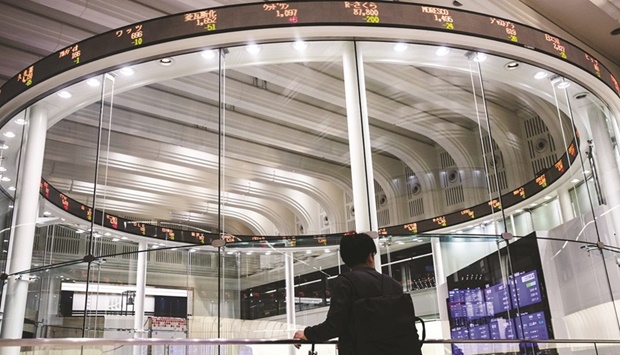 An electronic ticker displays share prices at the Tokyo Stock Exchange. The Nikkei 225 closed down 0.8% to 26,865.19 points yesterday.
