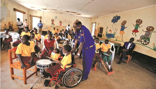 Salesioh Muriithi, Senior Superintendent of Police and the Officer Commanding Police Division (OCPD) in Endebess, watches as a pupil plays on a drum at the St Lilian Special School for physically challenged children where he volunteers as a music tutor, in Endebess town of Trans-Nzoia county.