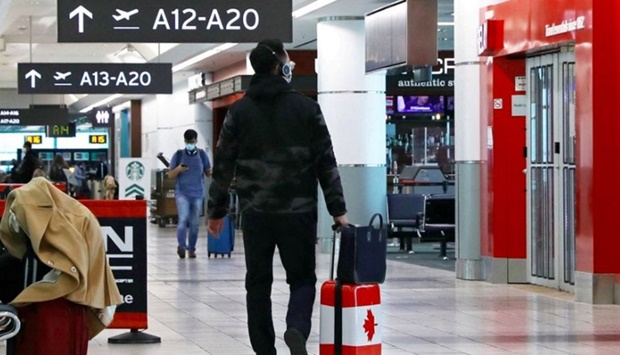 A United States-bound passenger walks in Toronto Pearson Airport's Terminal 3, days before new coronavirus disease (Covid-19) testing protocols to enter the U.S. come into effect, in Toronto, Ontario, Canada December 3, 2021.