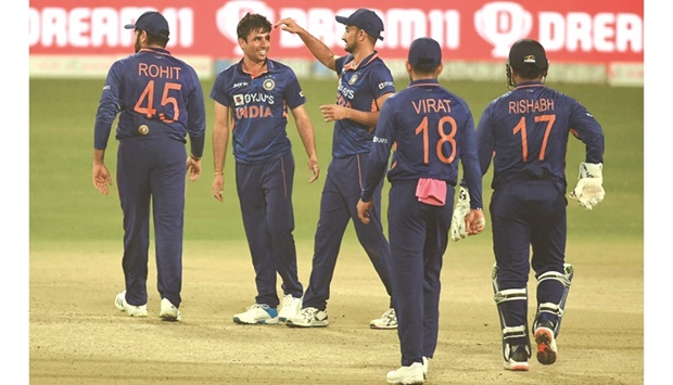 Indiau2019s Ravi Bishnoi (second from left) celebrates with teammates after the dismissal of West Indiesu2019 Rovman Powell during the first Twenty20 match at the Eden Gardens in Kolkata yesterday. (AFP)