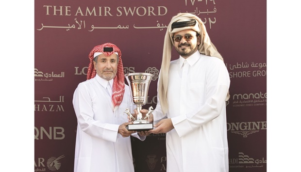 His Highness Sheikh Mohamed bin Khalifa al-Thani presents the Thoroughbred Sprint Cup to HE Sheikh Joaan bin Hamad al-Thani following the victory of Al Shaqab Racingu2019s Lauded at the HH The Amir Sword Festival at Qatar Racing and Equestrian Clubu2019s Al Rayyan Park on Thursday. PICTURES: Juhaim