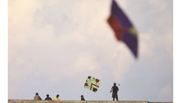 Youths in Rawalpindi fly kites on their rooftops during the Basant Kite Festival despite a ban imposed by the authorities.