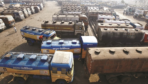 Oil tankers are seen parked at a yard outside a fuel depot on the outskirts of Kolkata. In India, there are expectations the big state-owned fuel retailers will hike prices sharply following the elections that end next month.