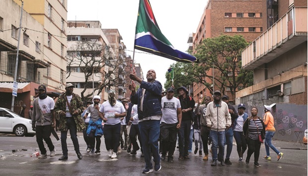 Members of the anti-foreigners movement, the so called u201cOperation Dudulau201d dance and sing xenophobic slogans during a gathering at a park in Hillbrow, Johannesburg, yesterday.