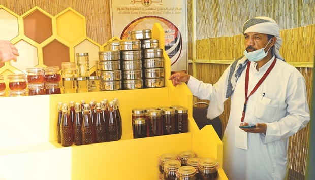 PAGE ONE PIC - A seller offering varieties of honey at the event. PICTURE: Shaji Kayamkulam.