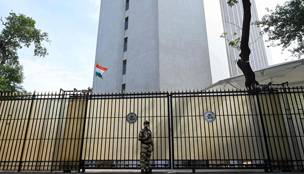 A security guard stands guard at the entrance to the Reserve Bank of India head office in Mumbai. 