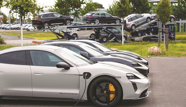 A line of Porsche Taycan electric automobiles outside a Porsche SE showroom in Berlin. Volkswagen is preparing an initial public offering of Porsche, seeking a listing of its most profitable asset to help boost the parentu2019s valuation and fund the push into electric vehicles.