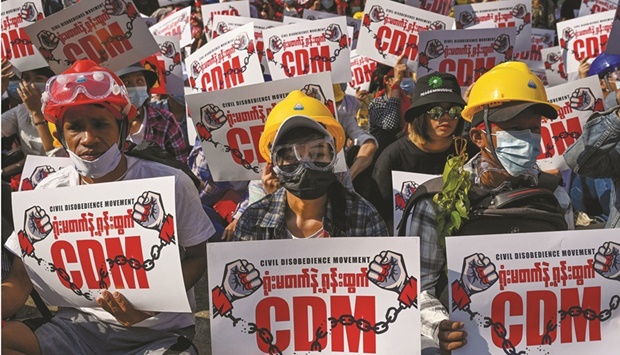 In this file photo taken on February 14, 2021, protesters hold up signs supporting the Civil Disobedience Movement (CDM) at a demonstration against the military coup in Yangon. It is among the nominees for this yearu2019s Nobel Peace Prize with the winner to be announced in early October. (AFP)