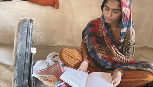 GREEN DREAM: Teenager Hira Bano pulls out her books from a briefcase in her house near Bhadla Solar Park late last year.