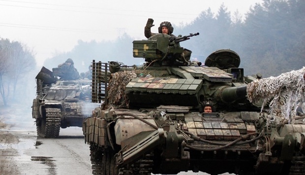 Ukrainian servicemen ride on tanks towards the front line with Russian forces in the Lugansk region of Ukraine. Anatolii Stepanov/AFP