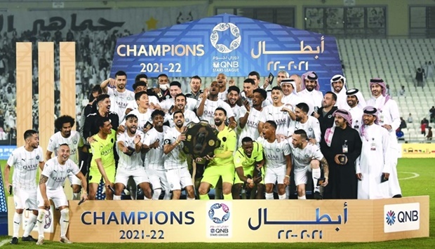 Al Sadd players, support staff and officials celebrate with Falcon Shield after winning the QNB Stars League yesterday. Al Sadd, who had clinched the title in the previous round, played out a 1-1 draw against Al Duhail at the Jassim Bin Hamad Stadium Friday. PICTURE: Shemeer Rasheed