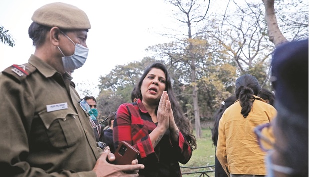 Sonu Jain, whose daughter is stuck in Ukraine, folds her hand in front of the police asking them to request the Indian government to evacuate the stranded students, near the Russian embassy in New Delhi, India, yesterday.