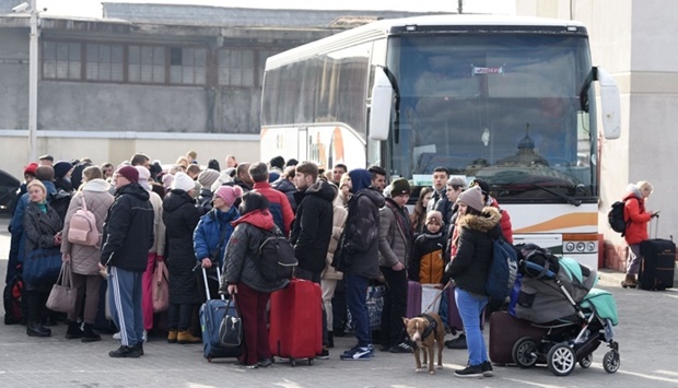 People wait for a bus to Poland at a bus station of the western Ukrainian city of Lviv