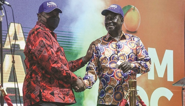 Kenyatta (left) with Odinga on stage of during the Orange Democratic Movement National Delegates Conference (ODMNDC) at Nairobiu2019s Kasarani stadium gymnasium.