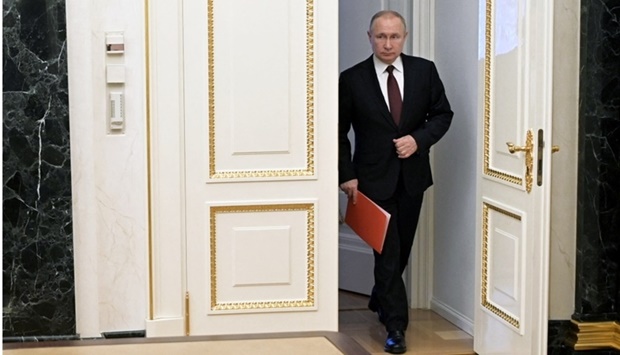 Russian President Vladimir Putin enters a hall before a meeting with members of the Security Council via a video link in Moscow, Russia February 25. Sputnik/Alexey Nikolsky/Kremlin via REUTERS