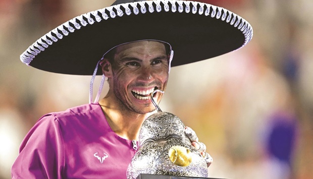 Spainu2019s Rafael Nadal celebrates with the trophy winning the Mexico ATP Open in Acapulco, Mexico. (AFP)