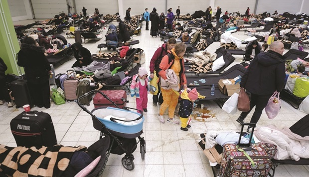 People fleeing Russian invasion of Ukraine rest at a temporary accommodation centre, in Korczowa, Poland, yesterday.