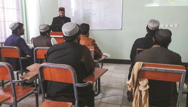 Students attend a class in the Helmand university in Lashkar Gah yesterday after the Taliban reopened public universities across some provinces. (AFP)