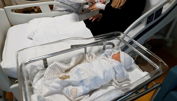 A member of the medical staff treats a Covid-19 positive woman next to her four-day old baby boy at the Basaksehir Cam and Sakura City Hospital in Istanbul, Turkey.