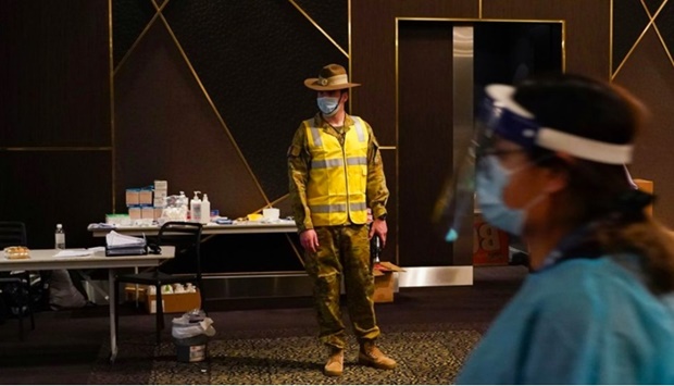 An Australian Defence Force member watches over a coronavirus disease (Covid-19) vaccination clinic at the Bankstown Sports Club as the city experiences an extended lockdown, in Sydney, Australia, August 3, 2021.