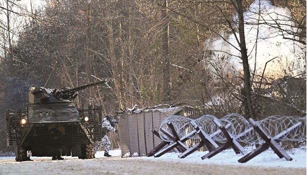 Servicemen take part in a joint tactical and special exercises of the Ukrainian Ministry of Internal Affairs, the Ukrainian National Guard and Ministry Emergency in a ghost city of Pripyat, near Chernobyl Nuclear Power Plant, yesterday. (AFP)