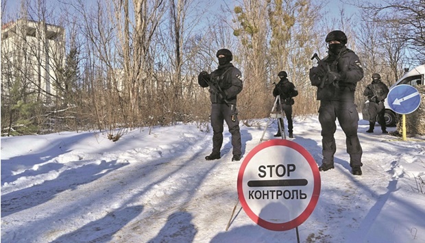Servicemen take part in a joint tactical and special exercises in the ghost city of Pripyat, near the Chernobyl nuclear power plant, yesterday.