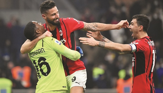 AC Milanu2019s Mike Maignan (left), Olivier Giroud (centre) and Alessio Romagnoli celebrate after their win over Inter Milan. (AFP)