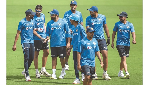 Indian captain Rohit Sharma (third from left) speaks with teammates during a training session in Motera yesterday, on the eve of the first ODI against West Indies. (AFP)