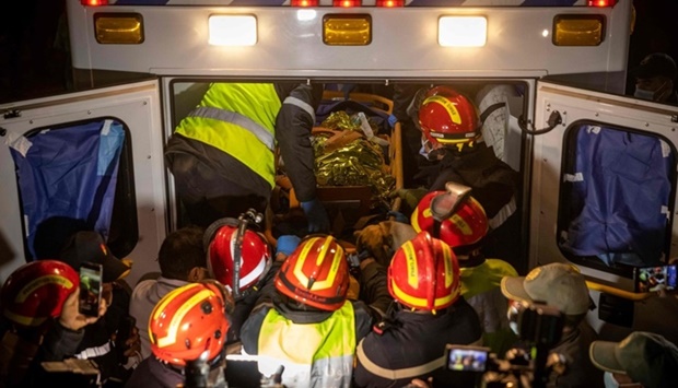 Moroccan emergency services teams carry five-year-old Rayan Oram into an ambulance after pulling him from a well shaft he fell into on February 1, in the remote village of Ighrane in the rural northern province of Chefchaouen on February 5. Photo by Fadel SENNA / AFP