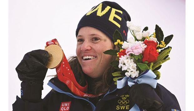 Gold medallist Swedenu2019s Sara Hector celebrates on the podium after winning the womenu2019s giant slalom during the Beijing 2022 Winter Olympic Games at the Yanqing National Alpine Skiing Centre in Yanqing yesterday. (AFP)