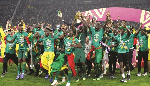 Senegal players celebrate with the trophy after winning the Africa Cup of Nations in Yaounde, Cameroon, on Sunday. (Reuters)