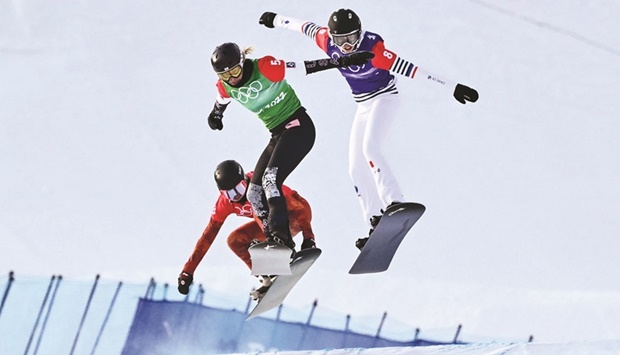 Canadau2019s Meryeta Odine (left), USAu2019s Lindsey Jacobellis (centre) and Franceu2019s Chloe Trespeuch compete in the snowboard womenu2019s cross final during the Beijing 2022 Winter Olympic Games at the Genting Snow Park P&X Stadium in Zhangjiakou yesterday. (AFP)