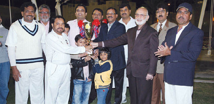 QALCO skipper Shahid receives the trophy from Qadir and Mahesh of Construction Development Company.