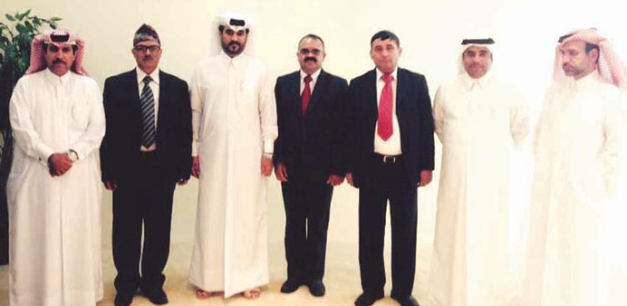 Team members with Ibrahim Abdullah al-Dehaimi and other Qatari officials.