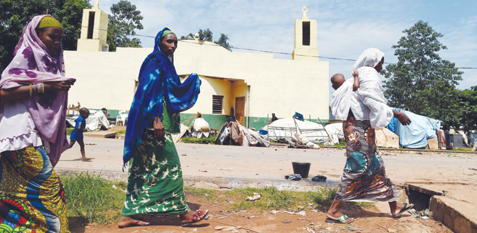 Women walk past the mosque of the PK 12 district of Bangui.