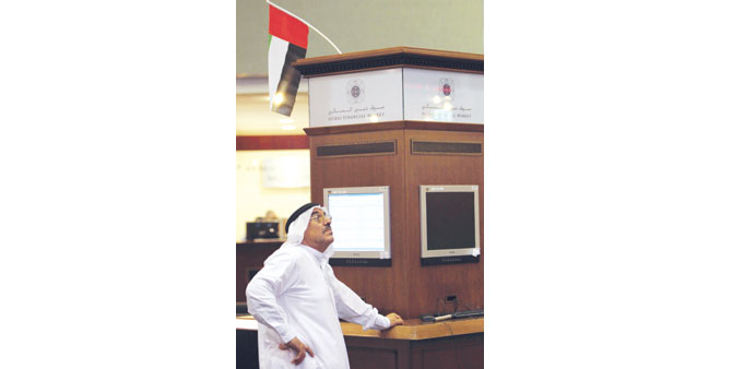 An Emirati investor follows the stock market developments at the Dubai Financial Market. Dubaiu2019s index rose 3% yesterday, partly recouping losses from