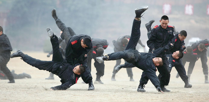 Paramilitary policemen practise combat skills during a drill at a training base in Deyang, Sichuan province. More than 800 people participated in the 