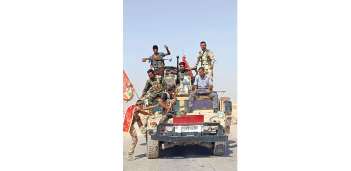 Iraqi forces arrive in Amerli yesterday to deliver assistance to the town after they broke a siege by Islamic State fighters.
